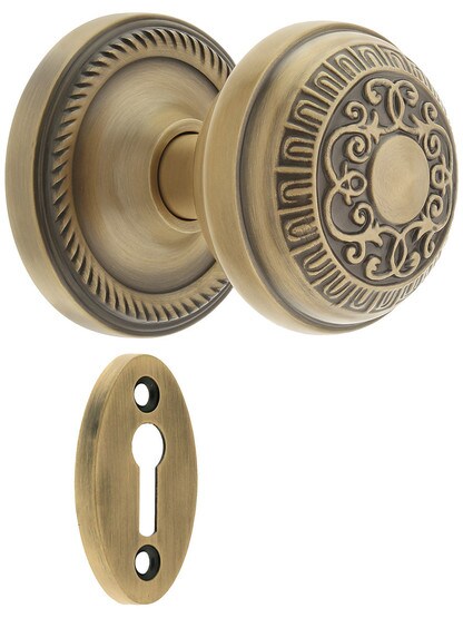 Rope Rosette Mortise Lock Set With Egg And Dart Door Knobs in Antique Brass.